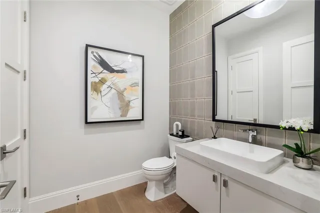 a bathroom with a toilet a sink and mirror