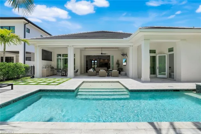 a view of a house with swimming pool having outdoor seating