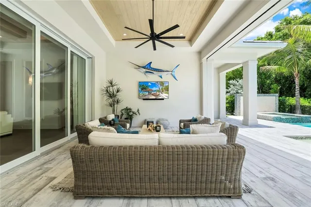 a living room with furniture a window and a chandelier