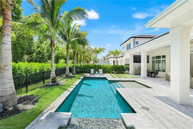 a view of a backyard with swimming pool