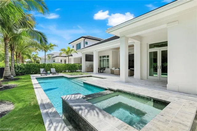 a view of a house with a yard patio and swimming pool