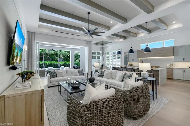 a living room with furniture large window and flat screen tv
