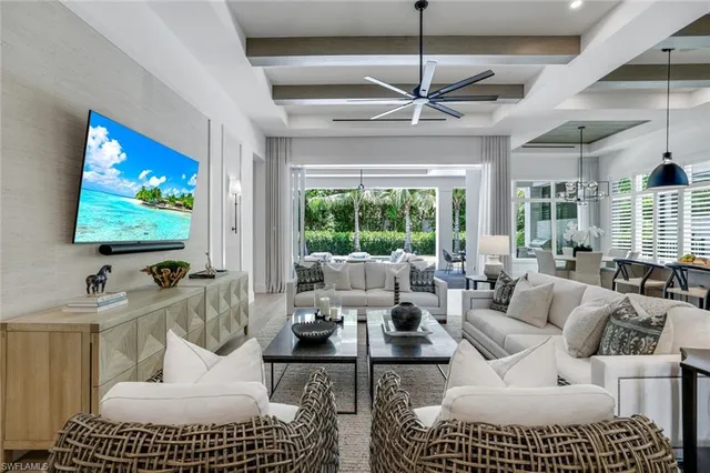 a living room with furniture a large window and a flat screen tv