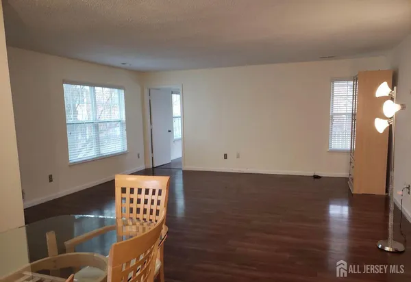 a view of room with window and wooden floor