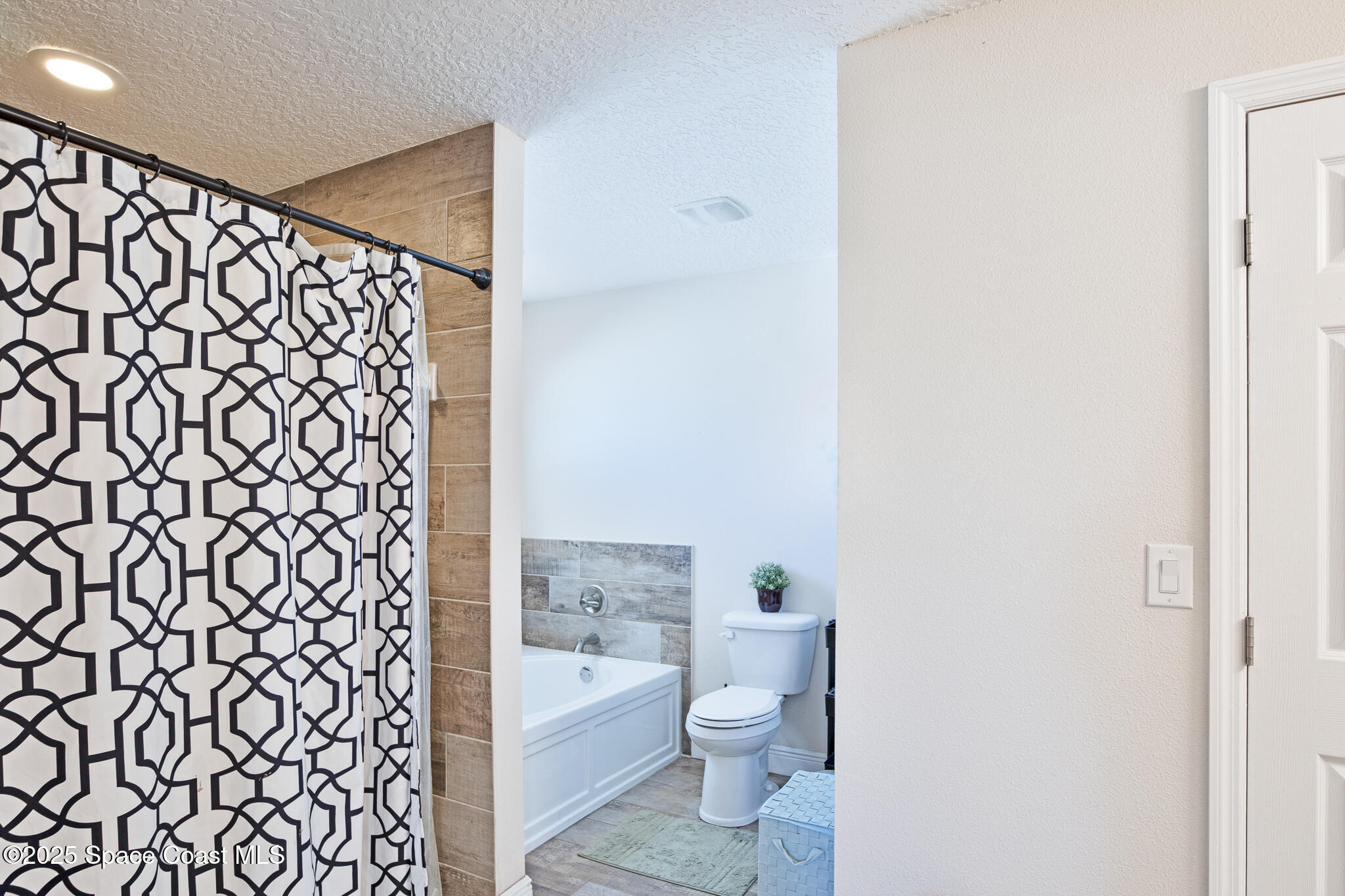 7350 Barbara Road Cocoa, FL 32927 - Photo 13 of 26 a bathroom with a toilet and a shower curtain