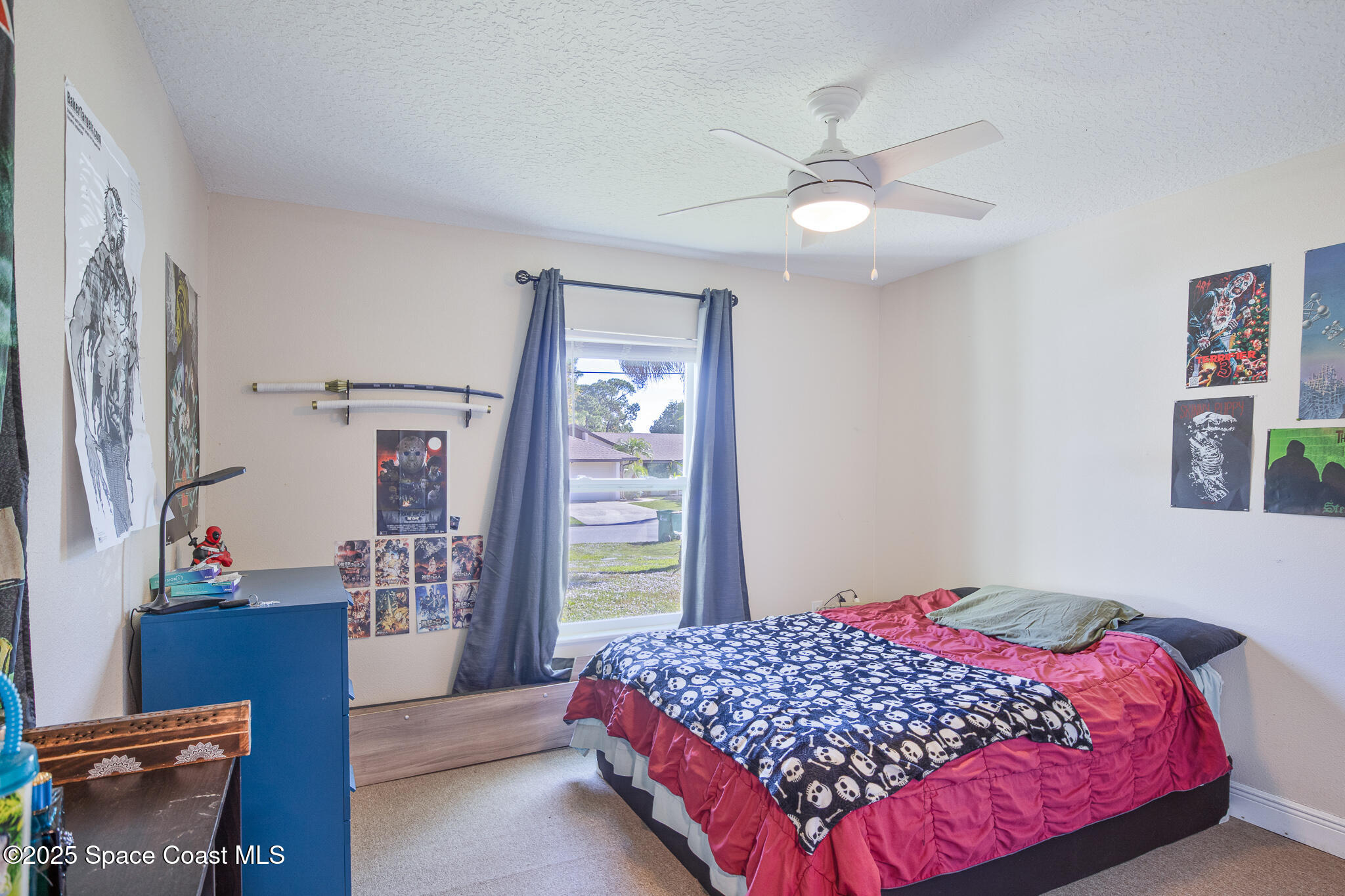 7350 Barbara Road Cocoa, FL 32927 - Photo 13 of 26 a bedroom with a bed and a chandelier