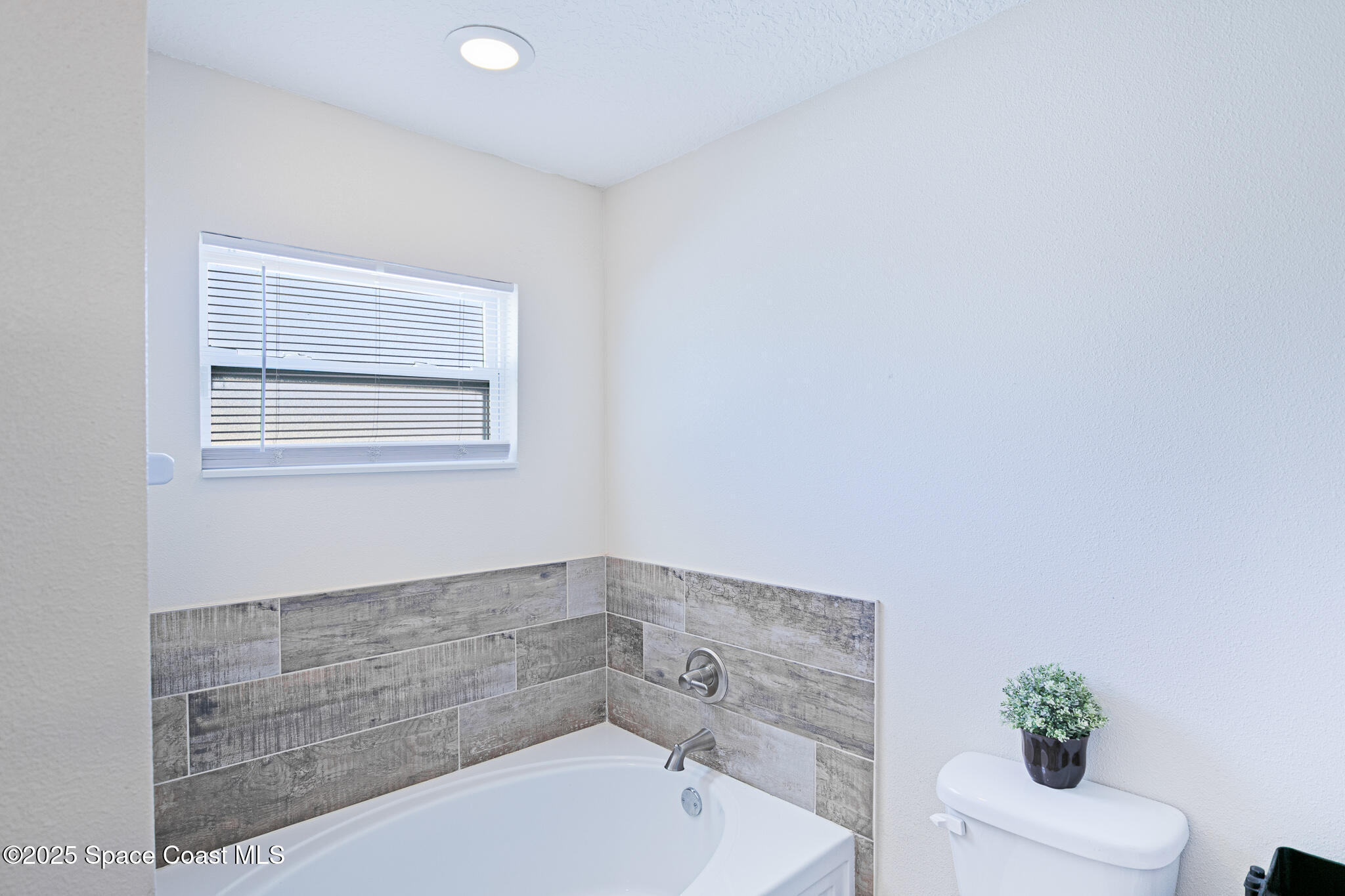 7350 Barbara Road Cocoa, FL 32927 - Photo 15 of 26 a bathroom with a tub sink and mirror