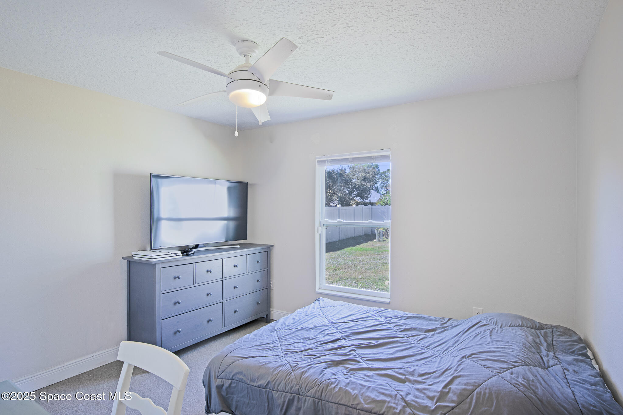 7350 Barbara Road Cocoa, FL 32927 - Photo 17 of 26 a bedroom with a bed and a window