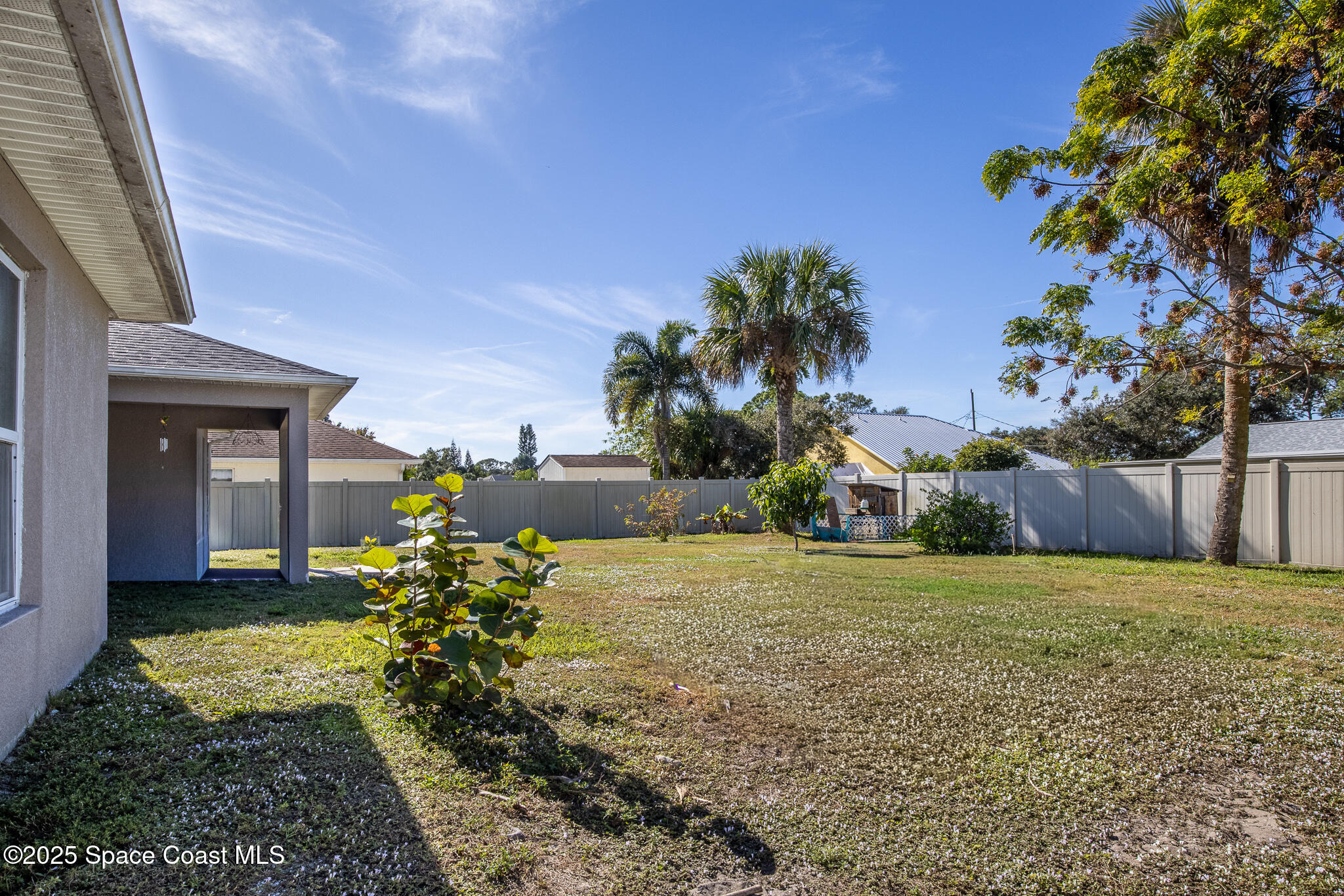 7350 Barbara Road Cocoa, FL 32927 - Photo 23 of 26 a view of a house with a yard and potted plants