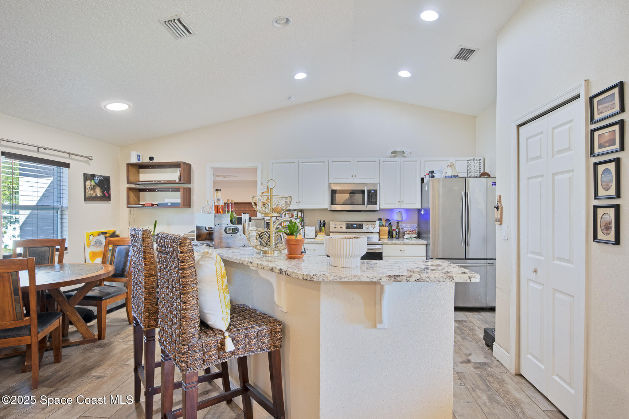 7350 Barbara Road Cocoa, FL 32927 - Photo 24 of 26 a kitchen with stainless steel appliances a refrigerator and a stove top oven