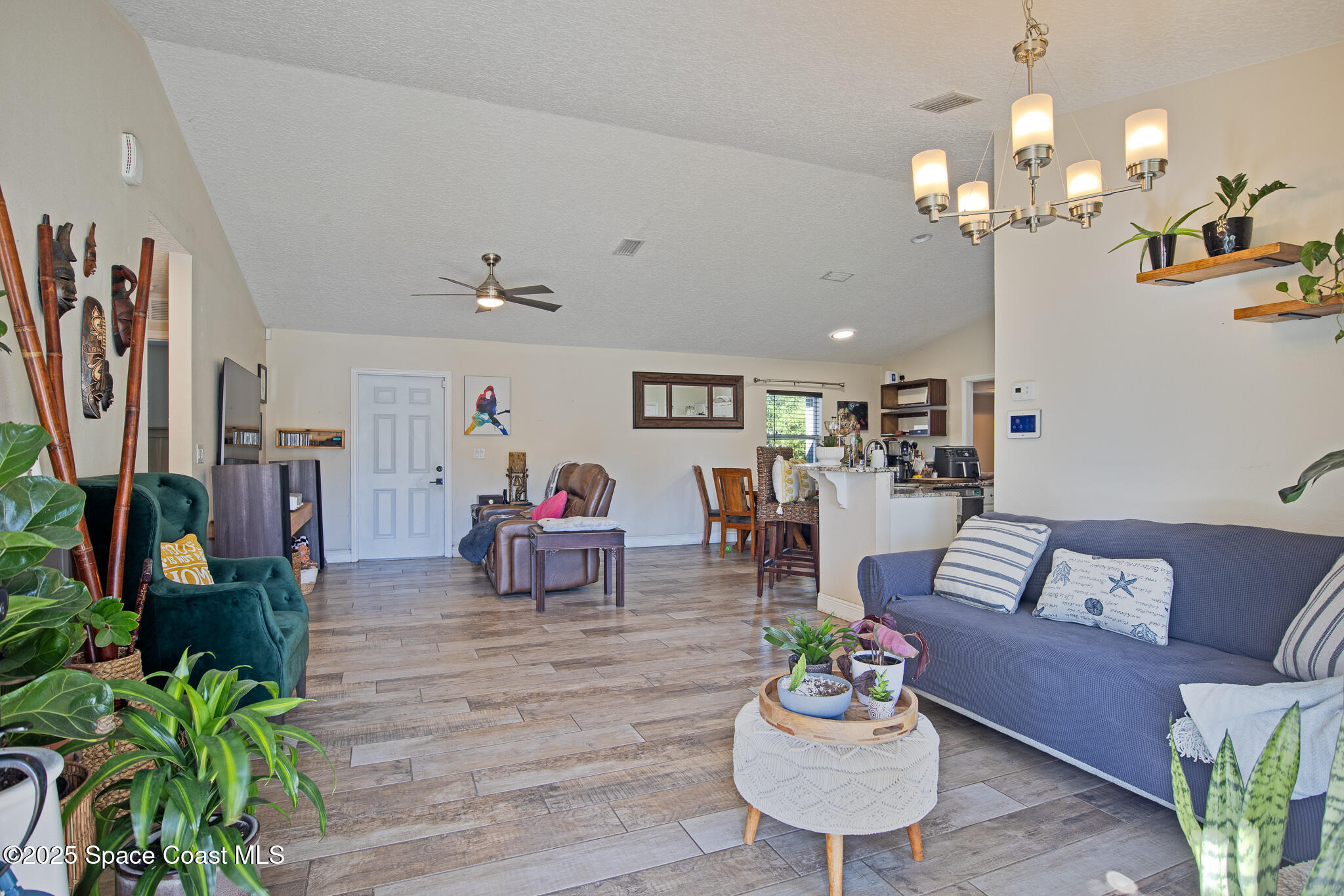 7350 Barbara Road Cocoa, FL 32927 - Photo 3 of 26 a living room with furniture and a chandelier