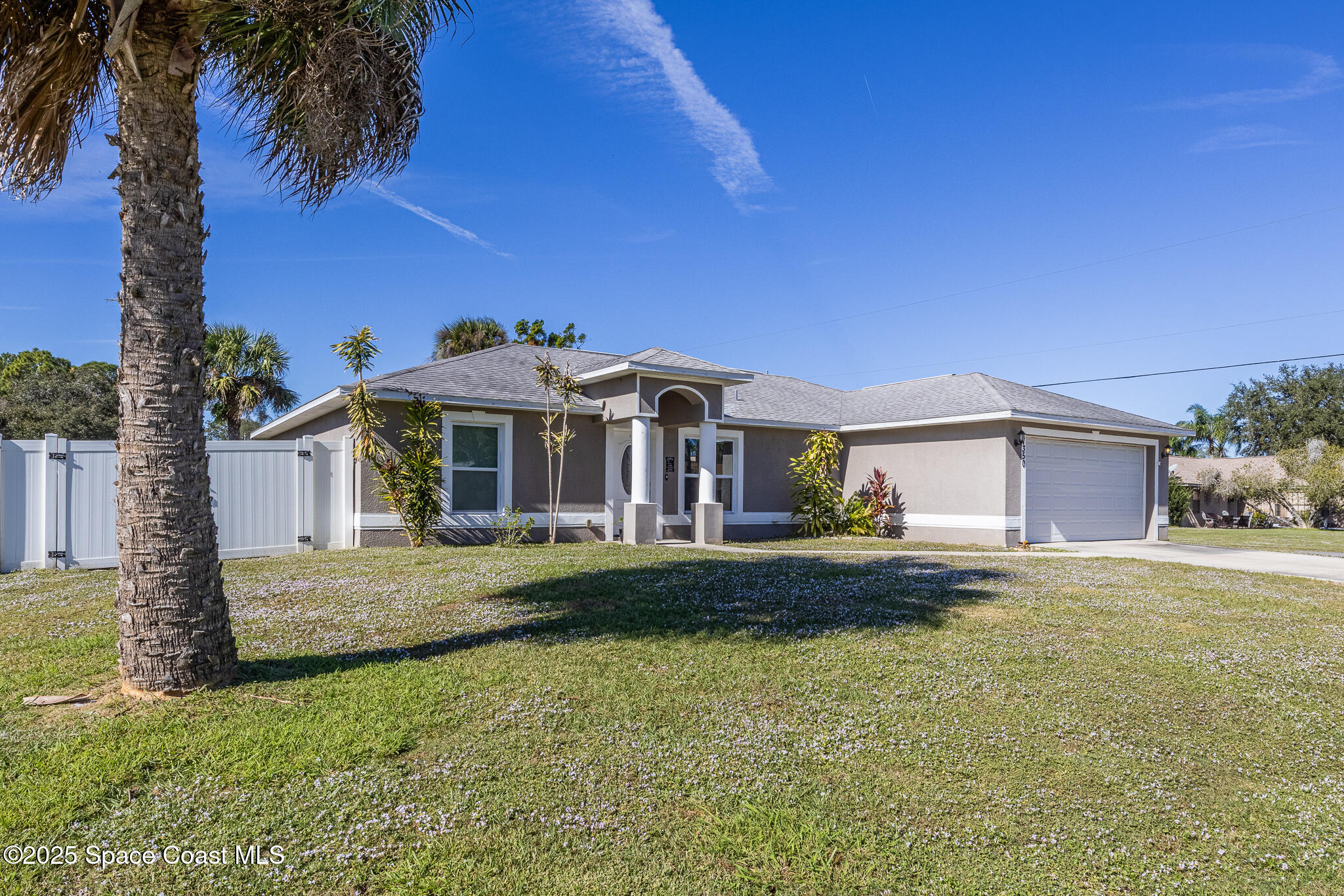 7350 Barbara Road Cocoa, FL 32927 - Photo 6 of 26 a front view of a house with a garden and yard