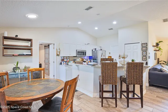 a dining room with furniture and window
