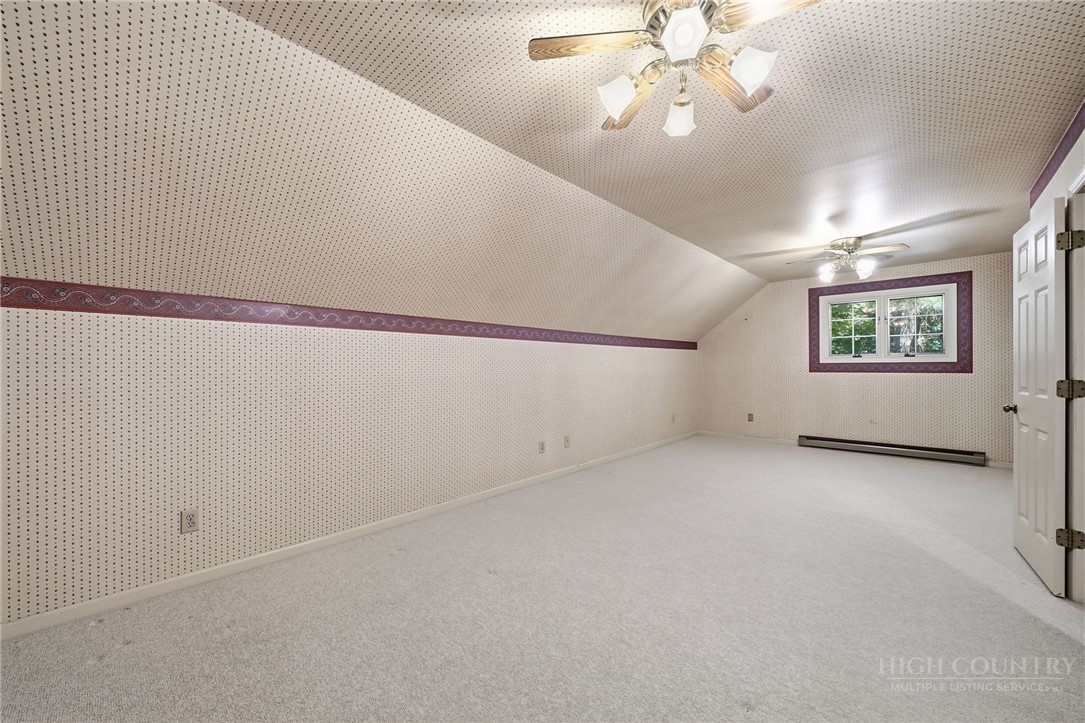 304 Glendale Drive Boone, NC 28607 - Photo 38 of 50 en empty room with windows and ceiling fan