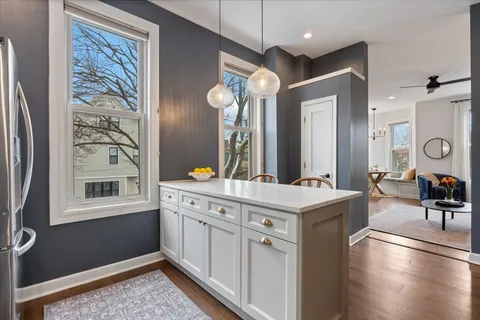 a kitchen with a cabinets and chairs