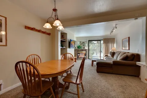 a living room with furniture a chandelier and a window