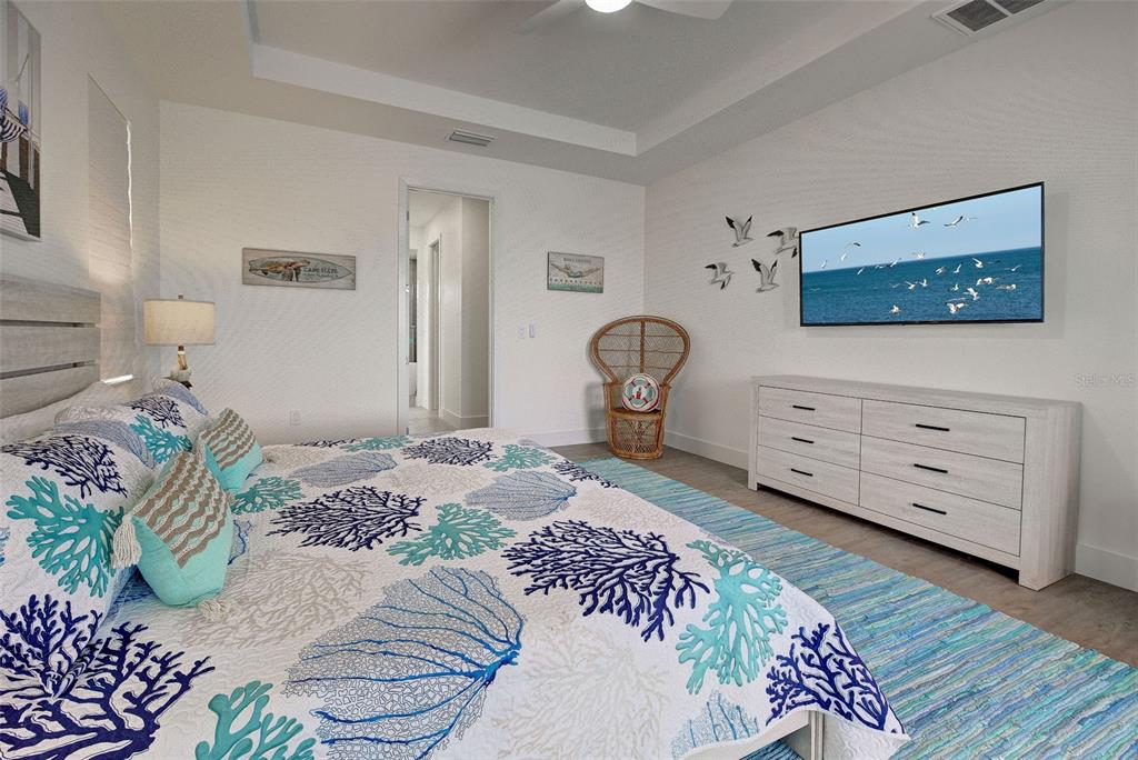 19 Windward Road Placida, FL 33946 - Photo 13 of 55 a bedroom with a bed and a dresser