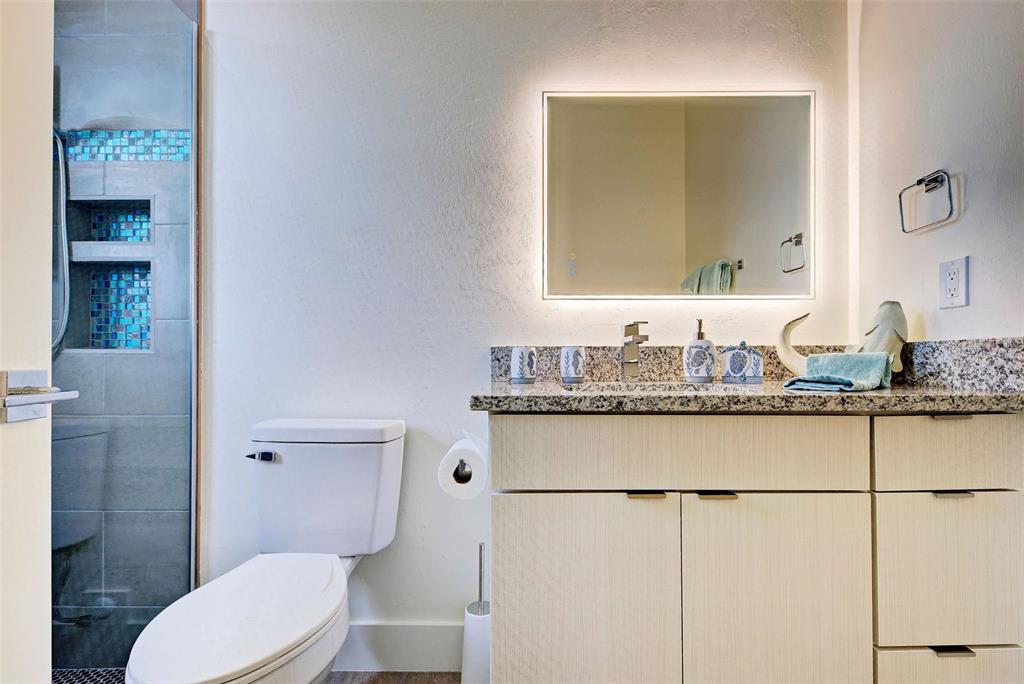 19 Windward Road Placida, FL 33946 - Photo 18 of 56 a bathroom with a granite countertop sink mirror vanity and toilet