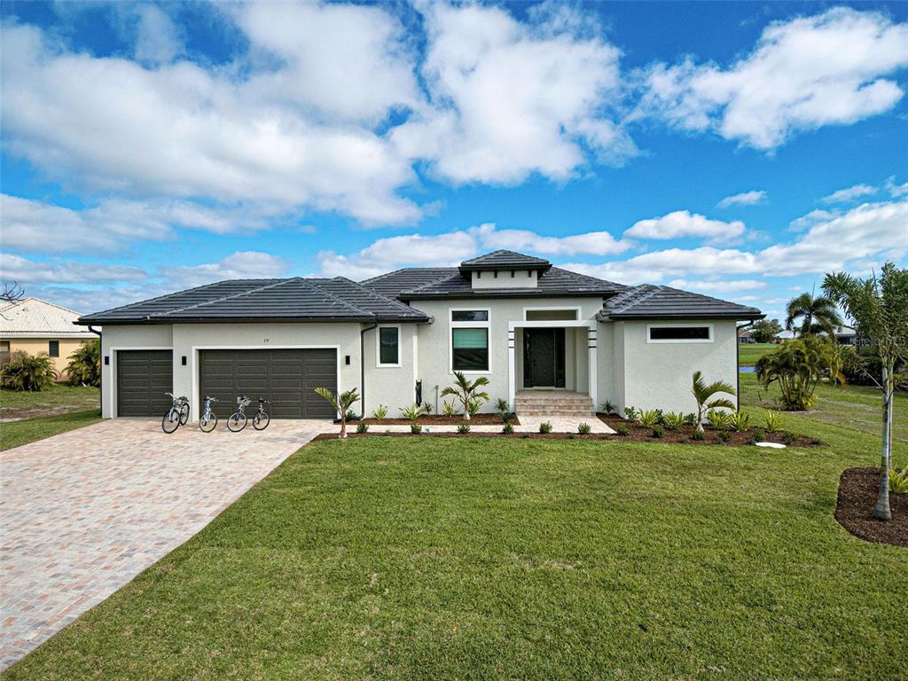 19 Windward Road Placida, FL 33946 - Photo 2 of 56 a front view of a house with a garden and yard