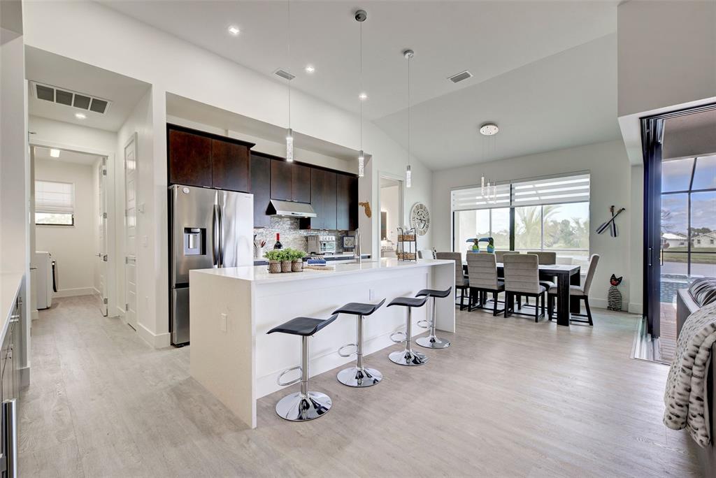 19 Windward Road Placida, FL 33946 - Photo 26 of 56 a kitchen with stainless steel appliances kitchen island granite countertop a refrigerator and cabinets