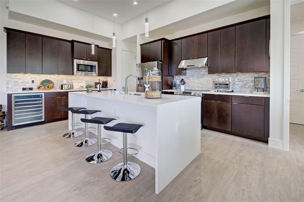 19 Windward Road Placida, FL 33946 - Photo 29 of 56 a kitchen with stainless steel appliances kitchen island granite countertop a sink and cabinets