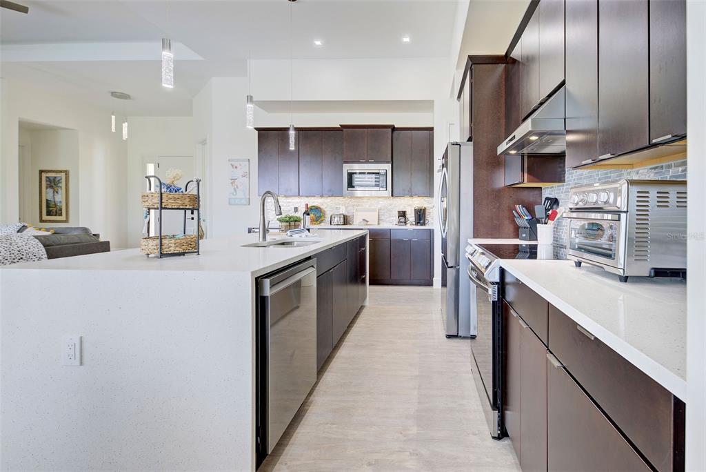 19 Windward Road Placida, FL 33946 - Photo 30 of 56 a kitchen with stainless steel appliances kitchen island granite countertop a sink stove and cabinets