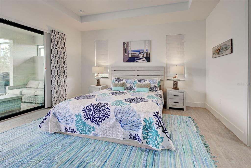 19 Windward Road Placida, FL 33946 - Photo 39 of 56 a bedroom with a bed and a wooden floor