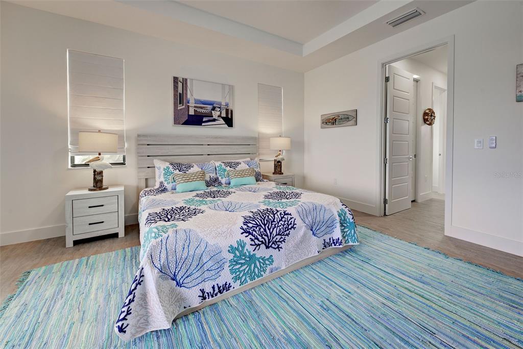 19 Windward Road Placida, FL 33946 - Photo 40 of 56 a bedroom with a bed and wooden floor