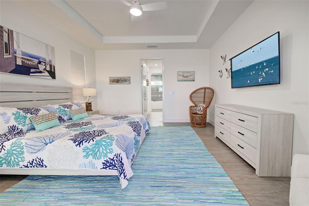 19 Windward Road Placida, FL 33946 - Photo 42 of 56 a bedroom with a bed and wooden floor