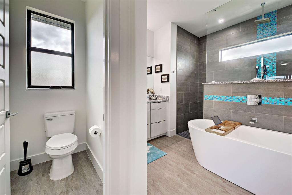 19 Windward Road Placida, FL 33946 - Photo 44 of 56 a bathroom with a white toilet sitting next to a bathroom sink and a tub