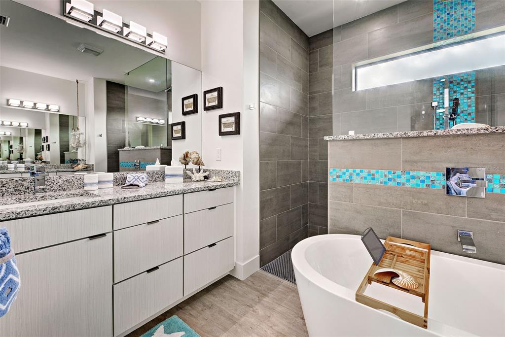 19 Windward Road Placida, FL 33946 - Photo 45 of 56 a bathroom with a granite countertop sink mirror and bathtub