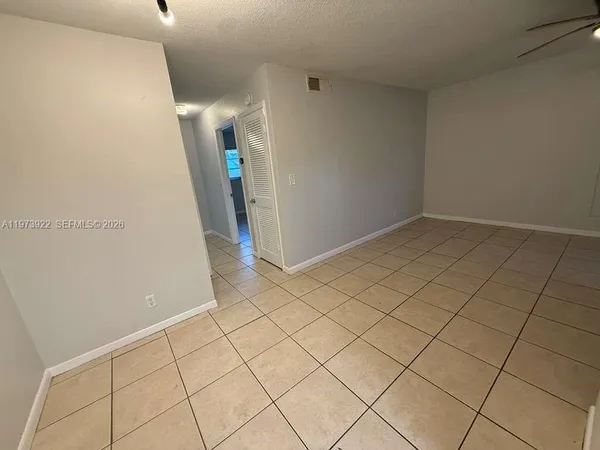 a kitchen with a sink a stove and white cabinets