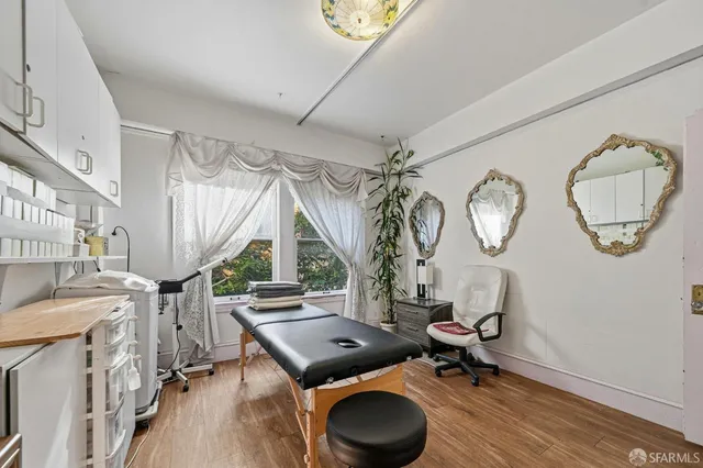 a view of an entryway with wooden floor and windows
