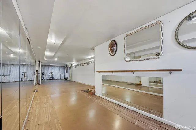 a view of a room with wooden floor