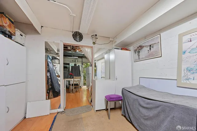 a view of empty room with wooden floor and fireplace