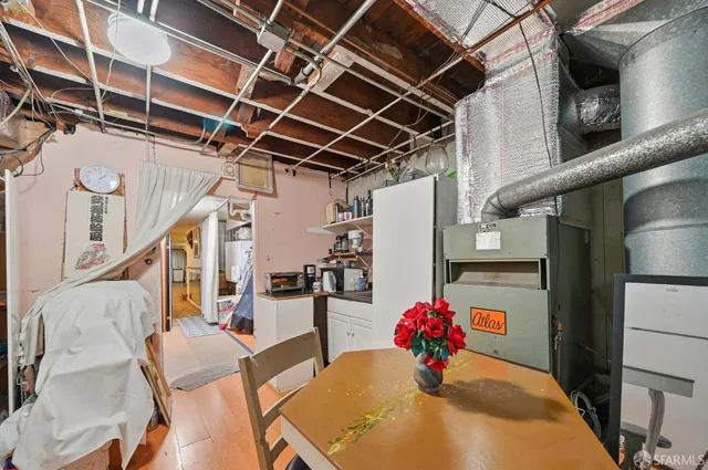 an empty room with wooden floor and a fireplace