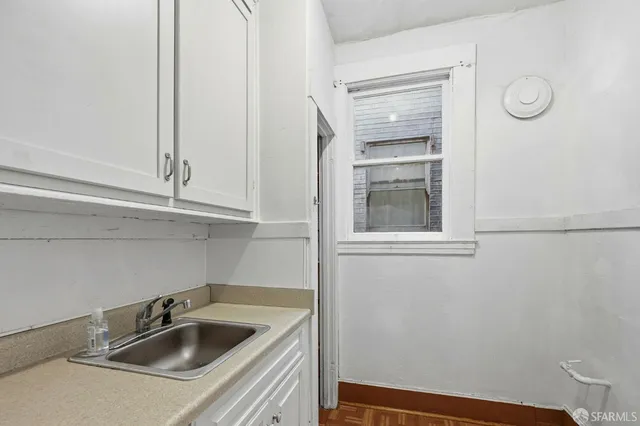 a view of workspace with wooden floor and cabinet