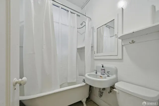 a living room with fireplace furniture and a large window