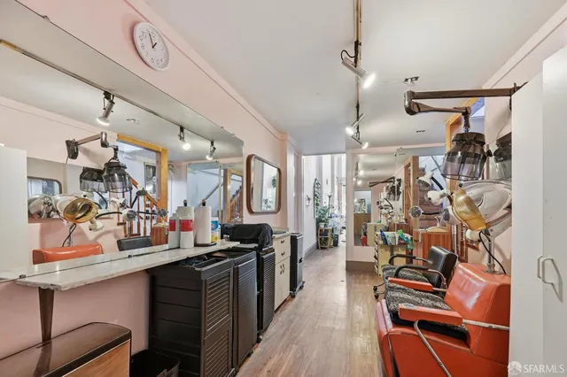 a living room with furniture a chandelier and a window