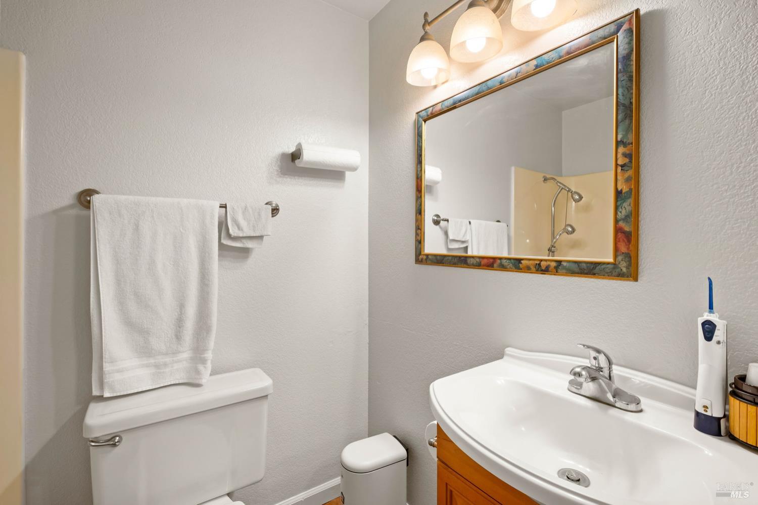 5044 Santa Rita Road El Sobrante, CA 94803 - Photo 17 of 27 a bathroom with a sink toilet and mirror