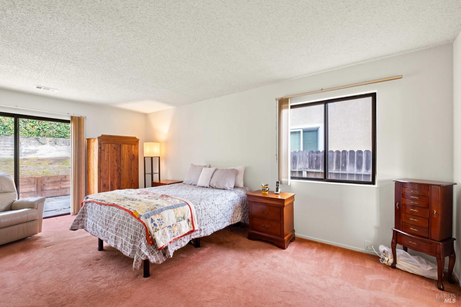 5044 Santa Rita Road El Sobrante, CA 94803 - Photo 18 of 27 a bedroom with a bed and a dresser next to a window