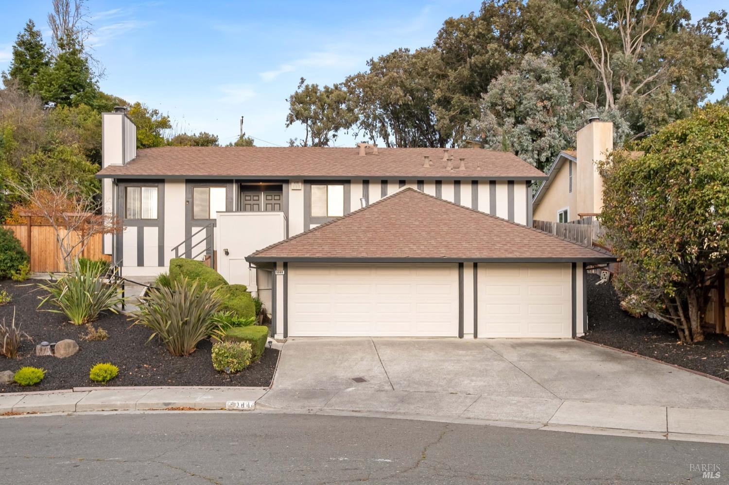 5044 Santa Rita Road El Sobrante, CA 94803 - Photo 2 of 27 a front view of a house with a garden and garage