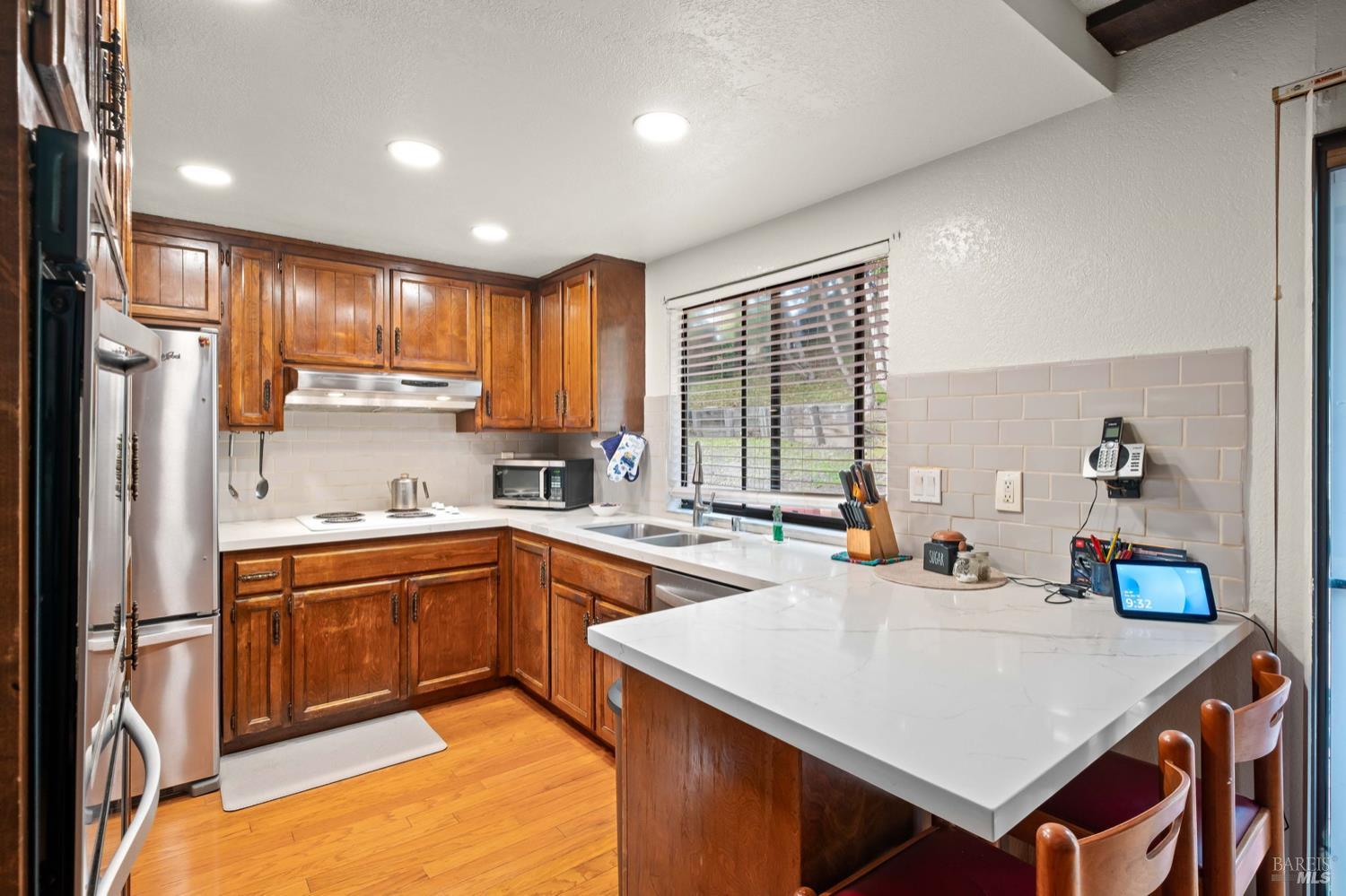 5044 Santa Rita Road El Sobrante, CA 94803 - Photo 9 of 27 a kitchen with stainless steel appliances granite countertop a sink a stove and refrigerator