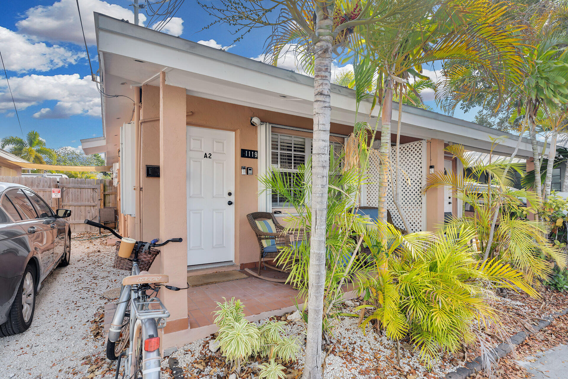 1119 Simonton Street, Unit A2 & C1 Key West, FL 33040 - Photo 3 of 20 a view of backyard with wheel chair potted plants and large tree