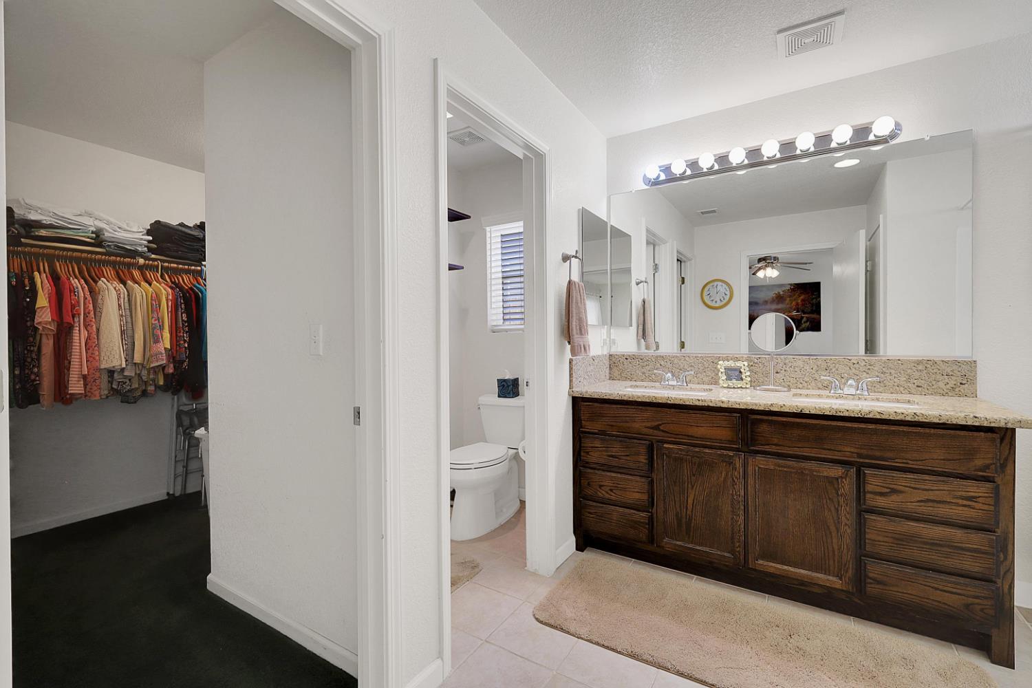 9840 Ellis Way Live Oak, CA 95953 - Photo 28 of 44 a spacious bathroom with a double vanity sink a mirror and a shower