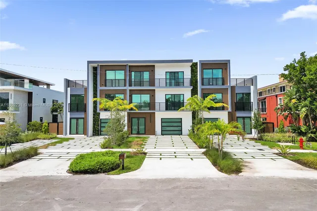 a living room with furniture kitchen view and a large window