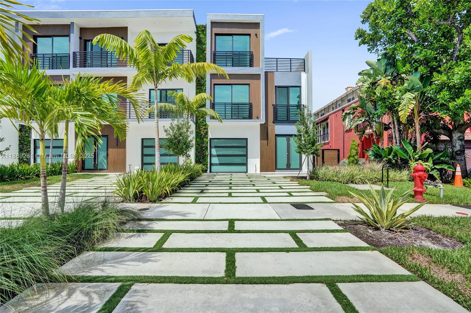 1825 Northeast 26th Avenue, Unit C Fort Lauderdale, FL 33305 - Photo 12 of 90 a building with trees in front of it