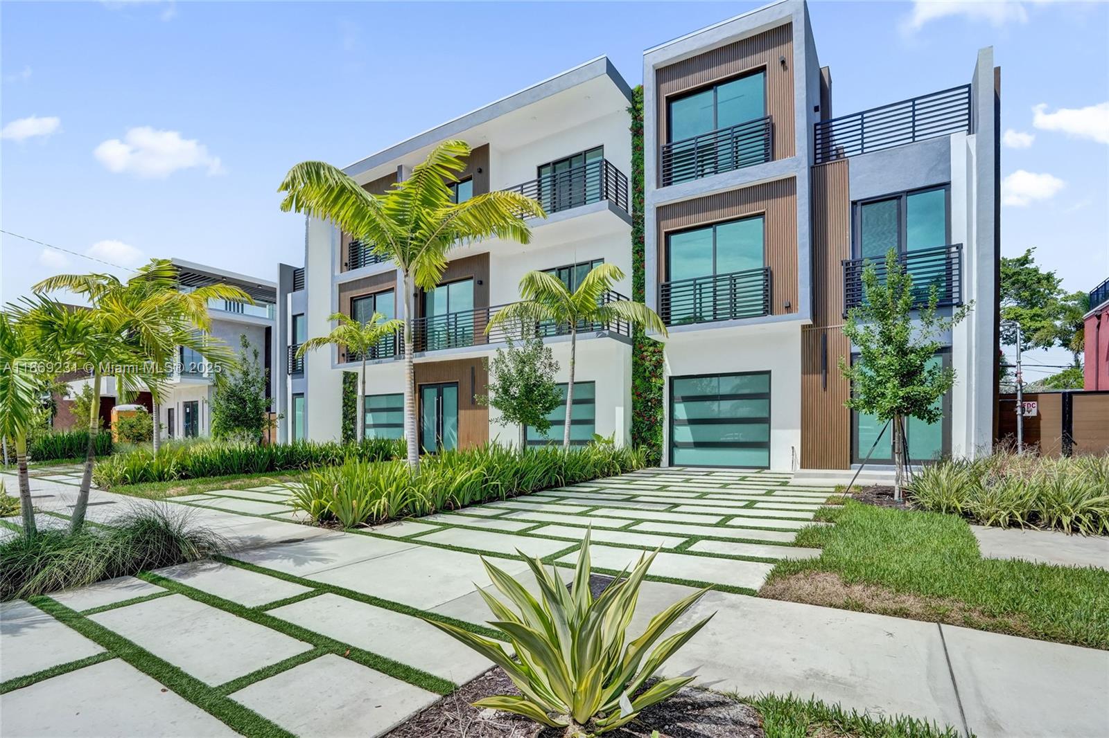 1825 Northeast 26th Avenue, Unit C Fort Lauderdale, FL 33305 - Photo 13 of 90 a front view of a building with a garden