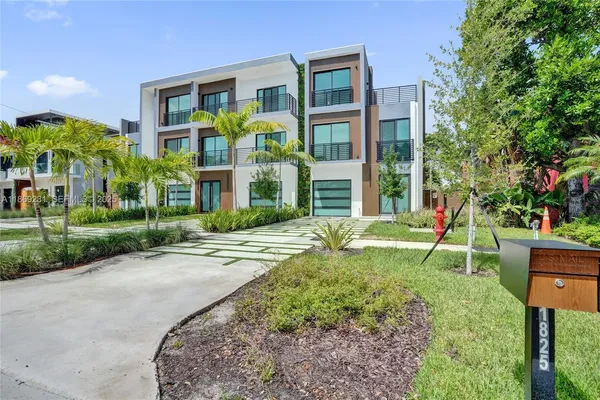 a kitchen with kitchen island a large counter top space a sink stainless steel appliances and cabinets