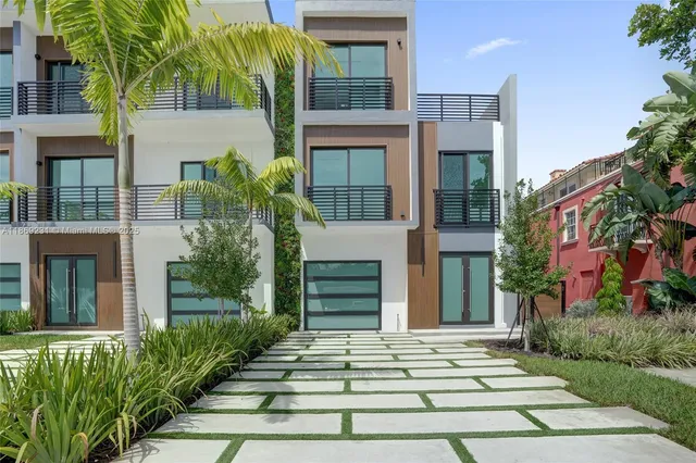 a kitchen with kitchen island a large counter top space a sink stainless steel appliances and cabinets